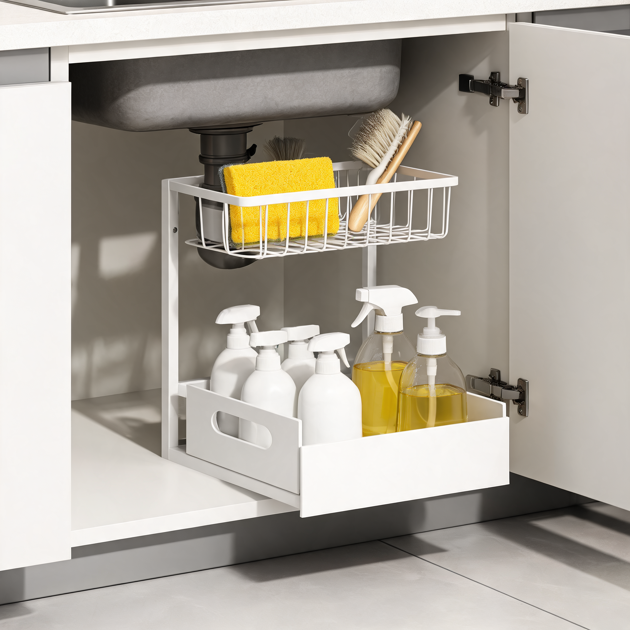 White pull-out organizer under a kitchen sink with the lower drawer slid out holding cleaning bottles